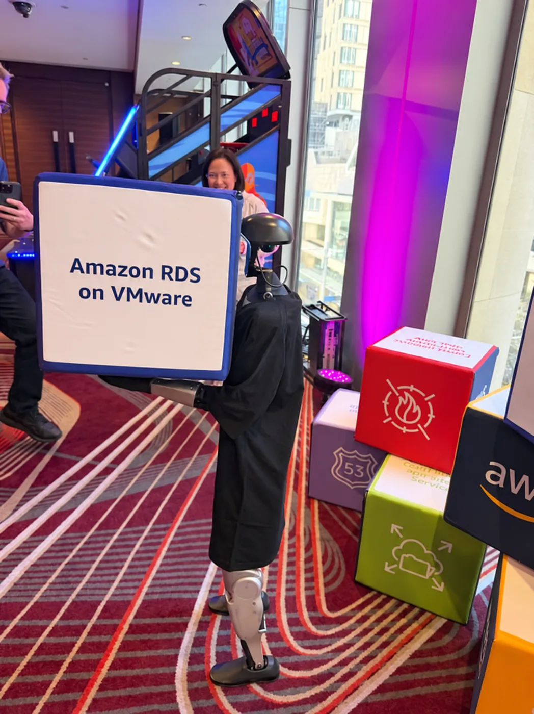 Rocco humanoid robot holding an Amazon RDS on VMware display cube