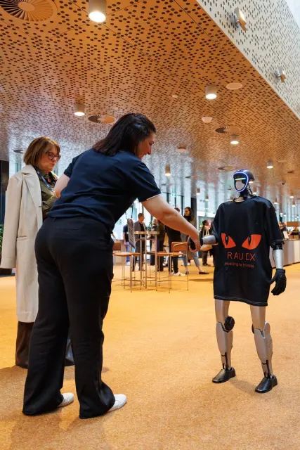 Humanoid robot greeting a guest at a live event