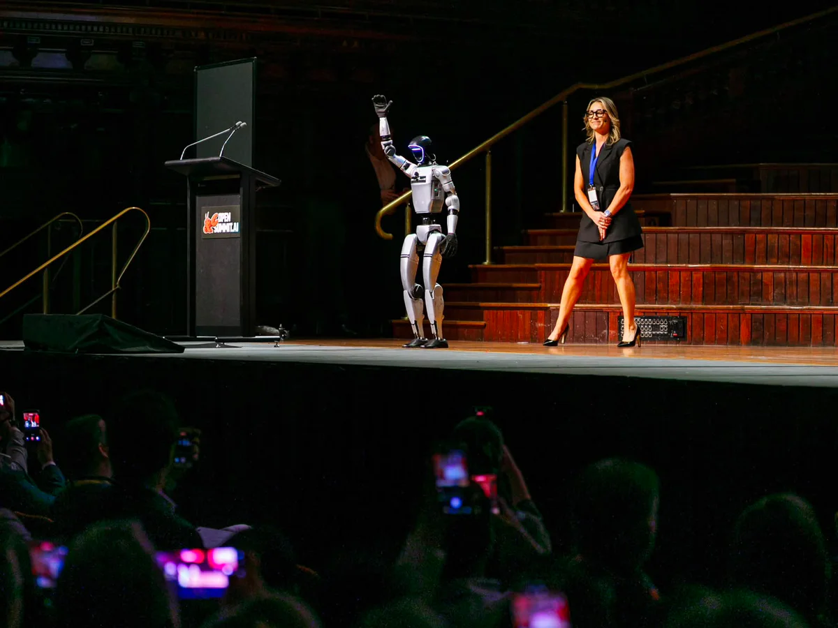 Rocco humanoid robot on stage at OpenSummit.AI Sydney in Sydney Town Hall while audience members film