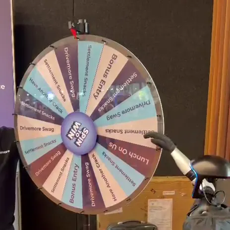Rocco humanoid robot spinning a prize wheel at an event